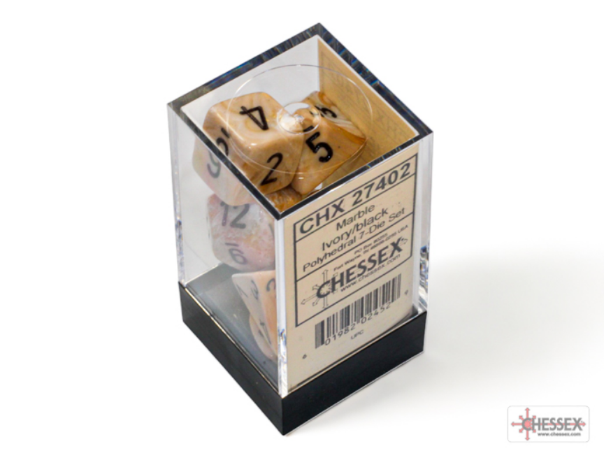Chessex Marble Ivory/Black 7-die set displayed in a clear box, featuring numbers in black and red on ivory dice.