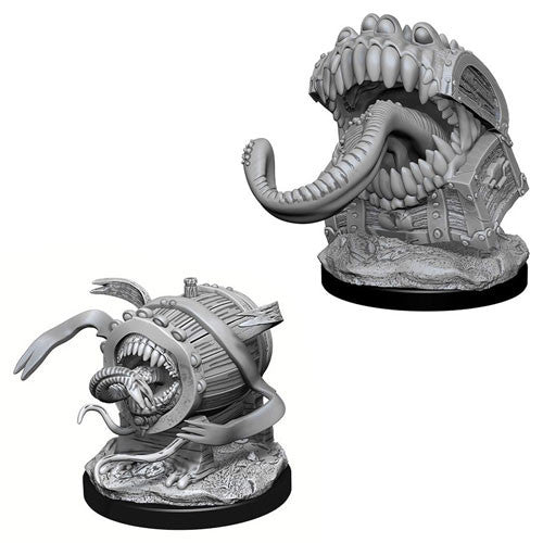 Unpainted Dungeons & Dragons miniatures featuring two mimics: one resembling a treasure chest and the other a barrel, both with open mouths and tentacle-like appendages.