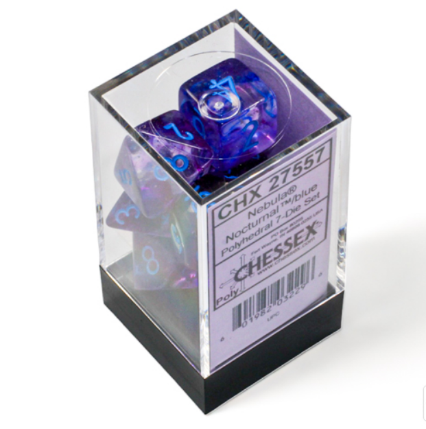 Chessex Nebula Nocturnal Blue Luminary 7 Die Set displayed in a clear box, showcasing vibrant blue and purple dice with luminous numbers.