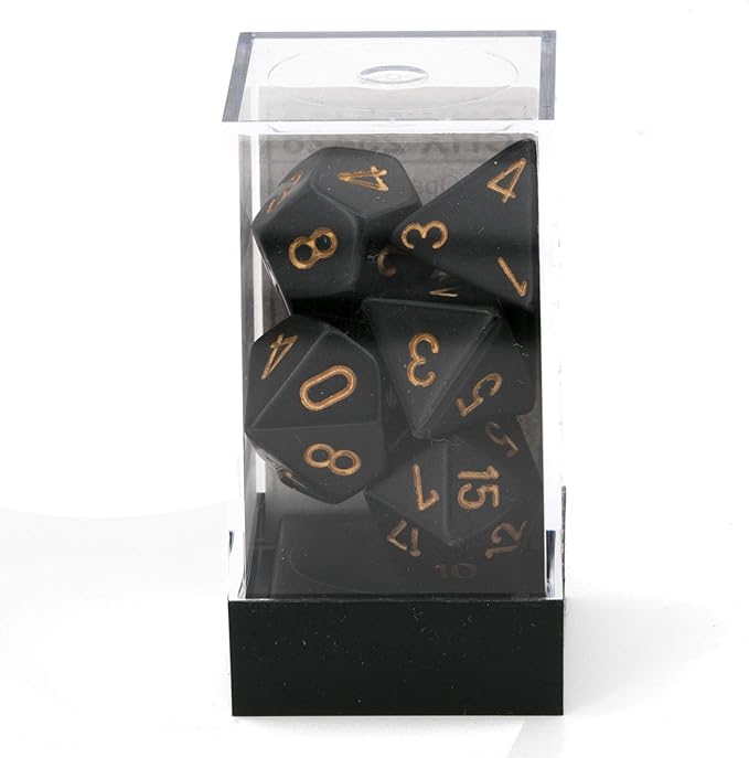 Chessex opaque black and gold 7-die set displayed in a clear plastic case, featuring various polyhedral dice.
