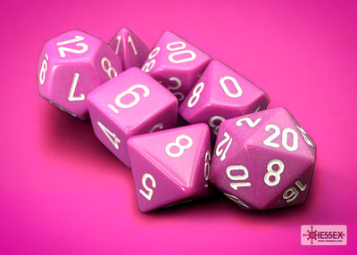 Opaque light purple and white 7-die set from Chessex, featuring various polyhedral dice on a pink background.