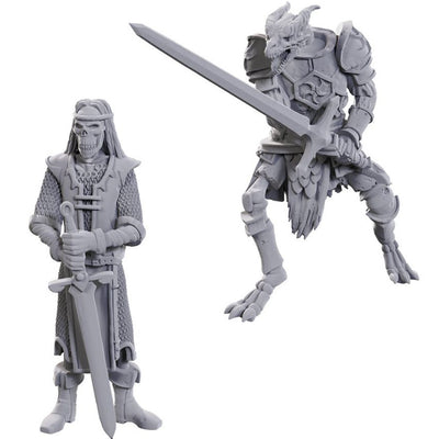 Two unpainted miniatures from Dungeons & Dragons: a Skeleton Knight with a sword and a skeletal warrior in armor.